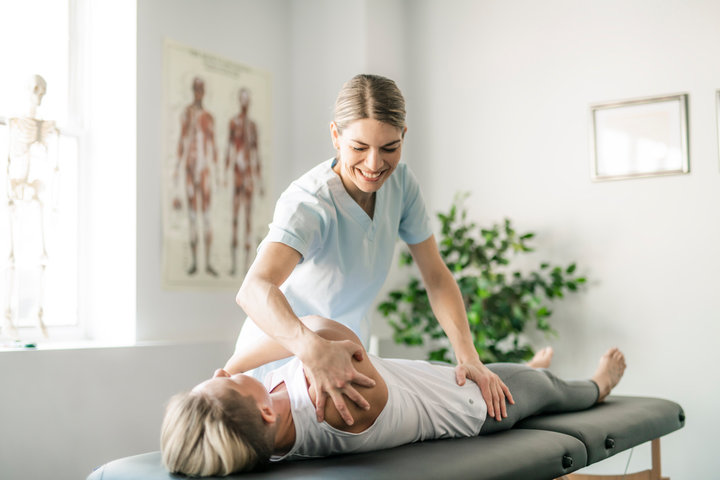 Physical therapist at Free Motion PT in Clearwater, Florida performing shoulder rehabilitation treatment to relieve pain and improve mobility